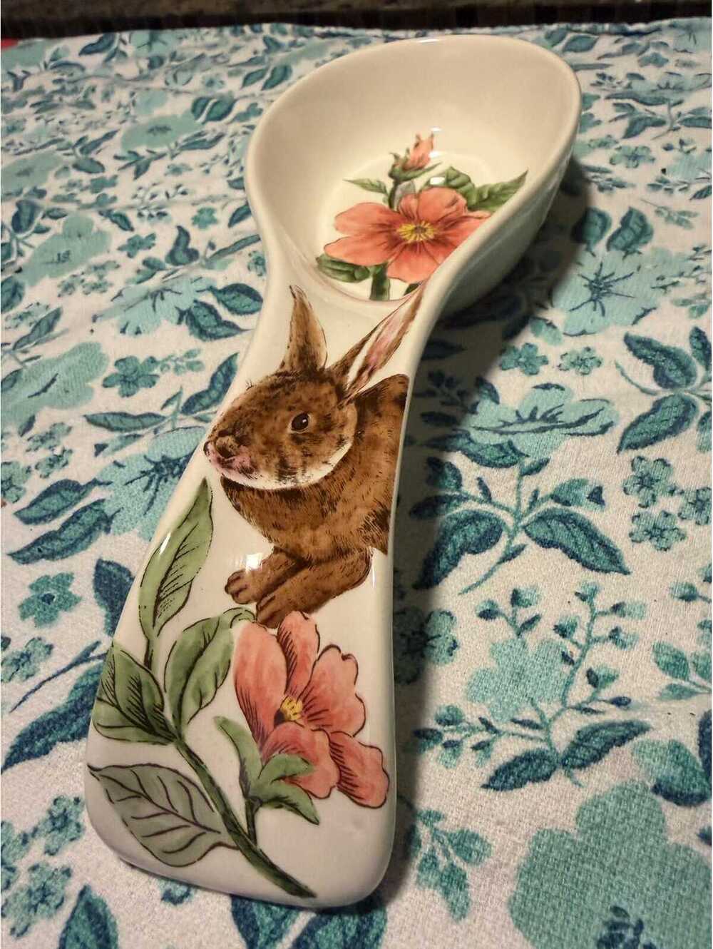 This is a Maxcera ceramic spoon rest featuring a rabbit and pink flowers.